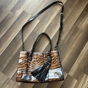 Patricia Nash Brown primrose tiger print handbag with black tassel.